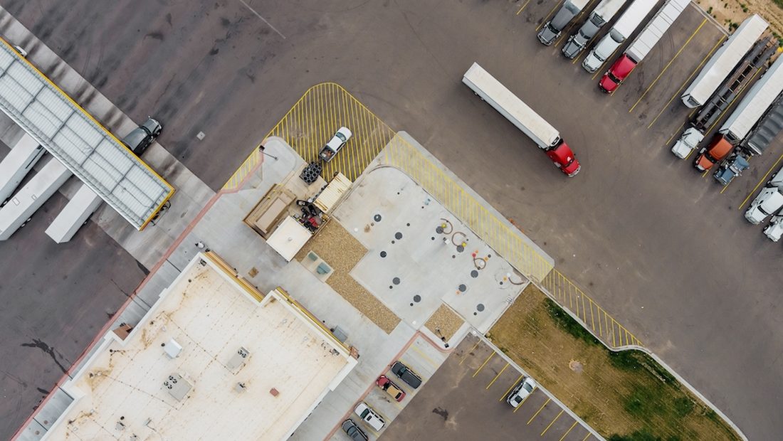 Aerial view of trucks and trailers staged across a freight yard