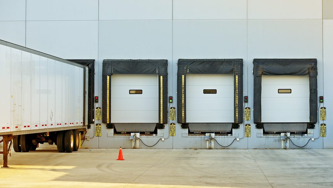 Loading dock doors with a trailer backed in at a distribution center